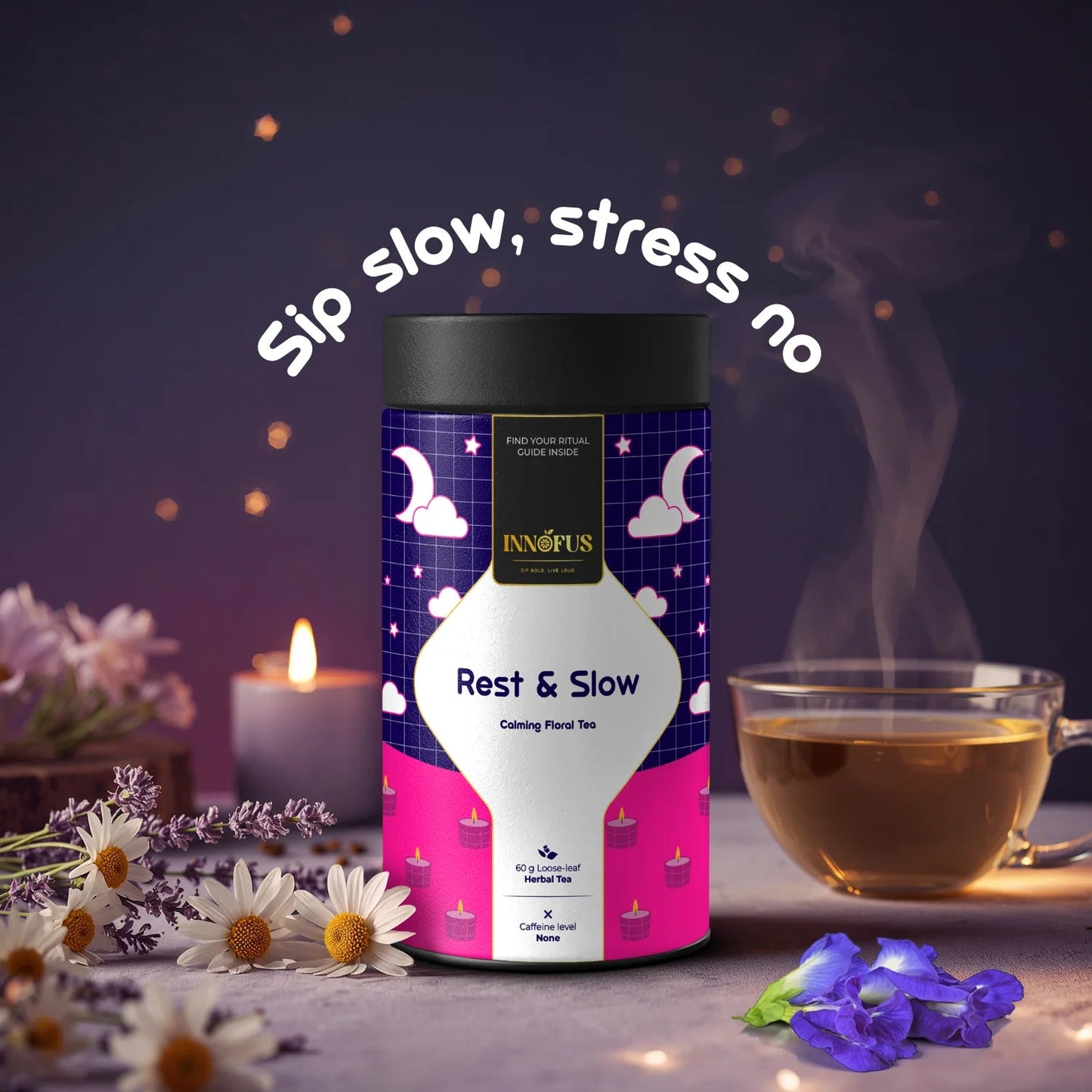 Rest & Slow herbal tea by Innofus for sleep and stress relief, calming blend with lavender, chamomile, blue pea; nighttime mood, steaming tea cup, candle, flowers and “Sip slow, stress no” tag.