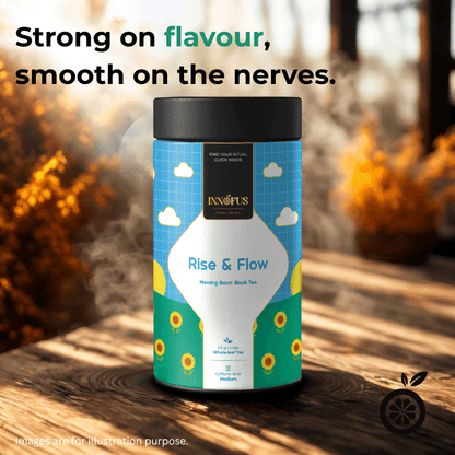 Rise & Flow morning boost black tea by Innofus, medium caffeine loose leaf in vibrant blue tin, steaming on sunlit wood table with Strong on Flavour, Smooth on the Nerves tagline.
